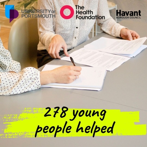 People sat at a desk looking at CVs