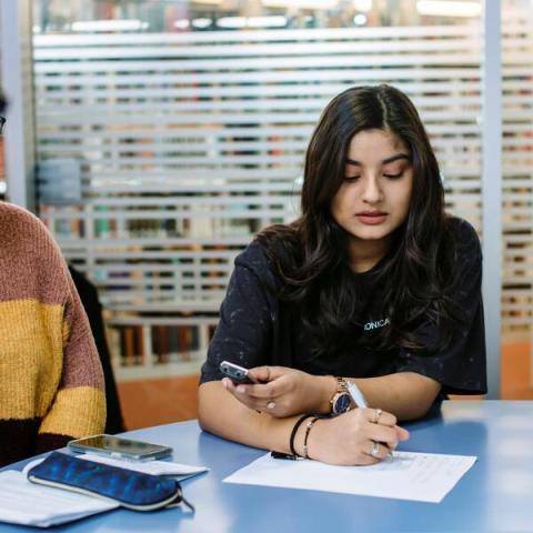 Girl writing on a paper.