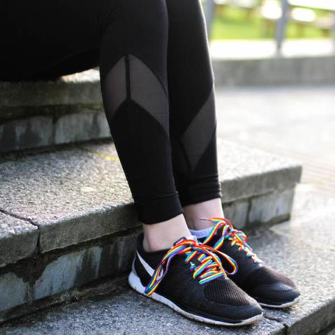 Student wearing trainers with rainbow laces