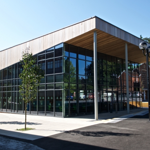 A modern building with trees around it, part of Peter Symonds College Campus