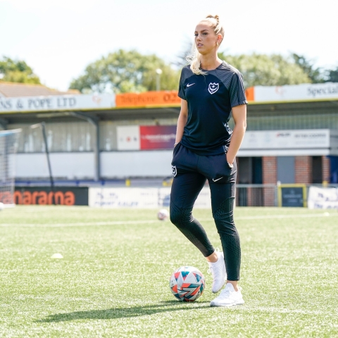 Woman standing on football pitch