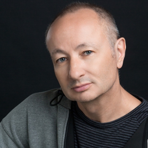 Headshot of Fenton Bailey looking to camera in black tshirt and grey hoodie