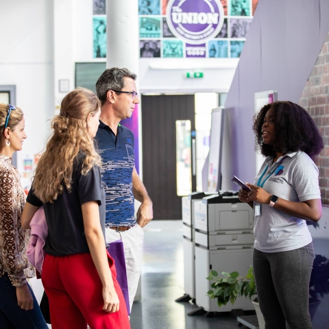 Student and parents at a HE fair