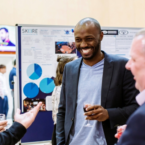 Three men at a business fair