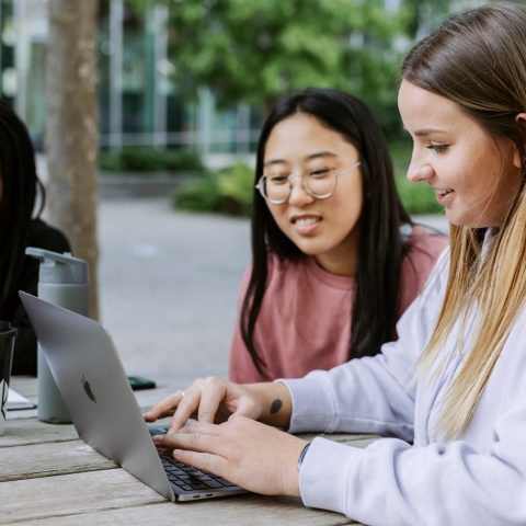 Three students studying on Laptop in Eldon centre outdoor space