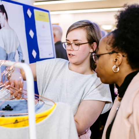 One student admiring self-employed placements student's startup