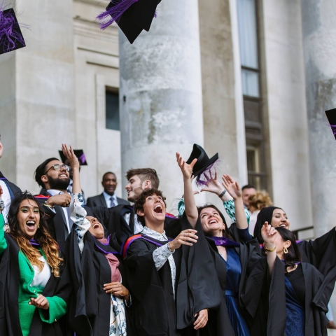 Graduates throwing hats 