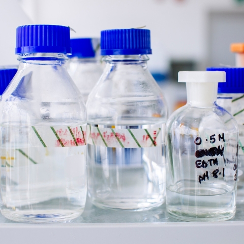 beakers and bottles containing a clear liquid
