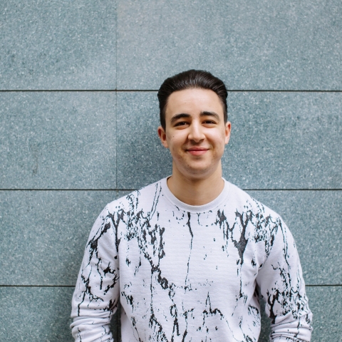 Group of students litter picking on Southsea seafront in front of a sign that reads 'Southsea'