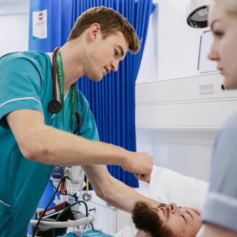 A student in scrubs in our Centre for Simulation in Health and Care