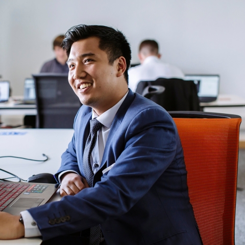 Male student working with laptop at University of Portsmouth