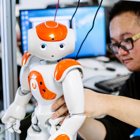 Robot being fixed by computer engineer