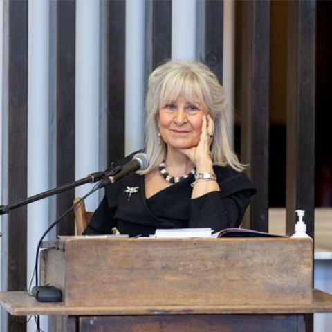 Baroness Helena Kennedy smiling to camera behind speech podium