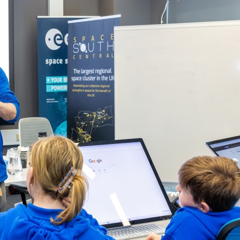 Jeremy Thomas in a teaching room, facing pupils from Miltoncross Academy during a workshop to design and build a water projected rocket