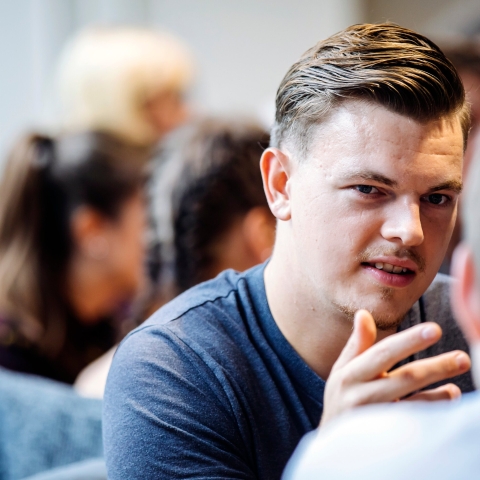 Young man in conversation with older man