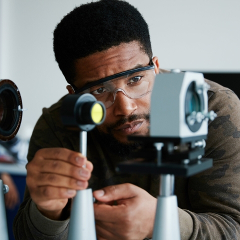 Male BAME scientist studying the Zeeman effect