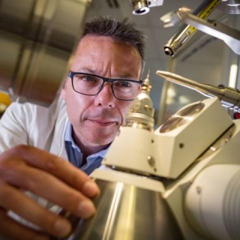 scientist inspecting scientific equipment