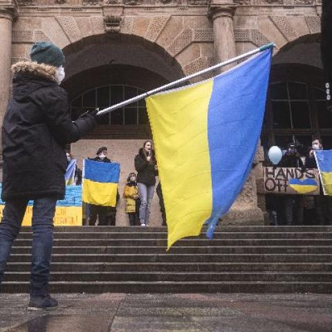 Boy waving flag - Photo by noah eleazar on Unsplash
