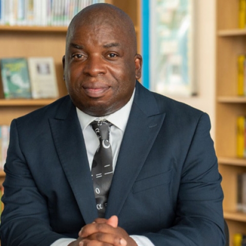Headshot of Professor Nira Chamberlain smiling to camera
