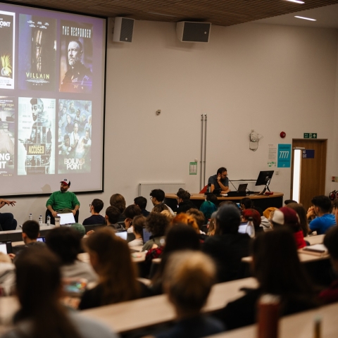 Group of people watching a presentation 
