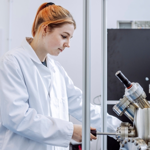 Female student working on a microscope