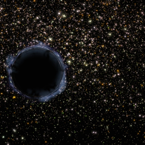 Image of a black hole in space, surrounded by stars