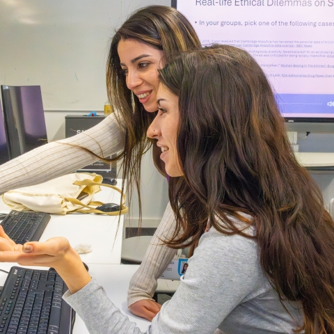 Two women collaborating on a computer 