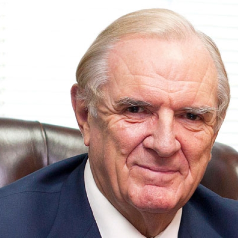 Sir Roger Fry smiling to camera in headshot