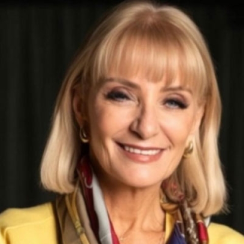Headshot of Rosemary Reed looking to camera and smiling wearing smart clothes