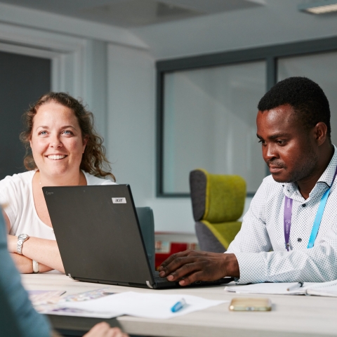 Male and female University of Portsmouth staff in business meeting