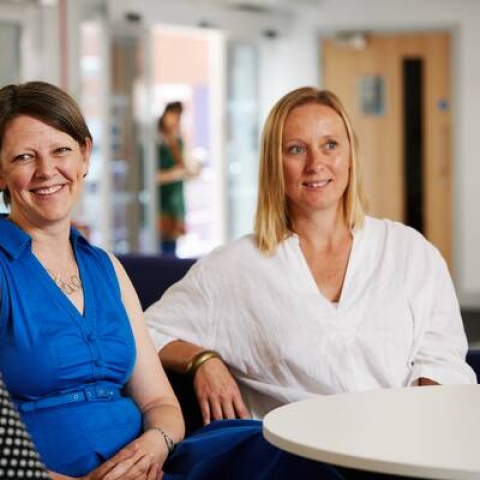 Three women sat down chatting 