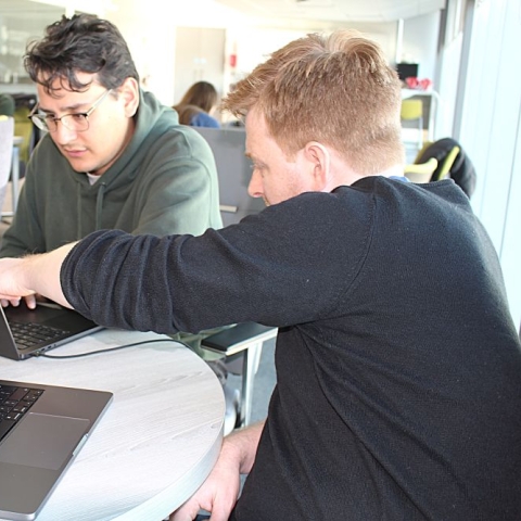 Two students looking at laptops