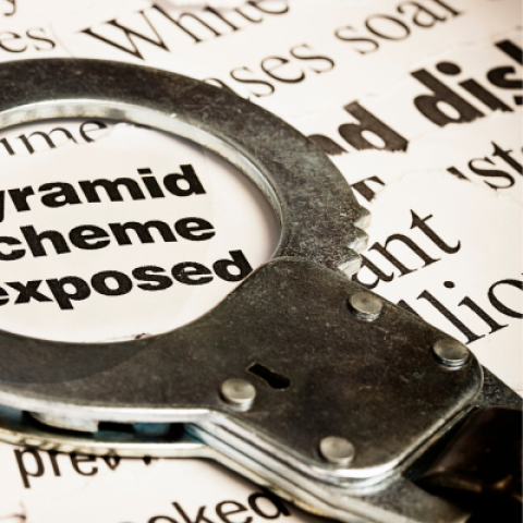 Handcuff on top of news article reading Pyramid scheme exposed