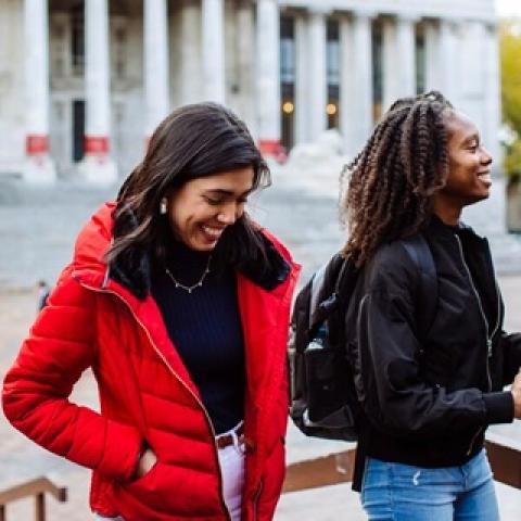 Two students laughing outside Portsmouth Guildhall