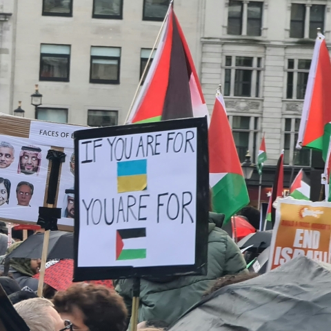 A crowd of people holding up signs demonstrating - Photo by Austin Crick on Unsplash