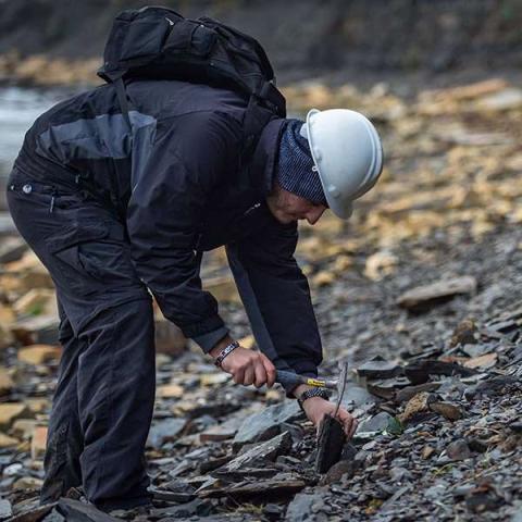 A person on field trip examining slate