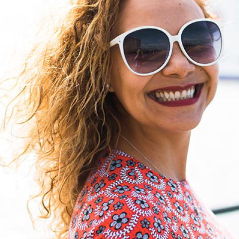 student smiling in the sun on Southsea pier