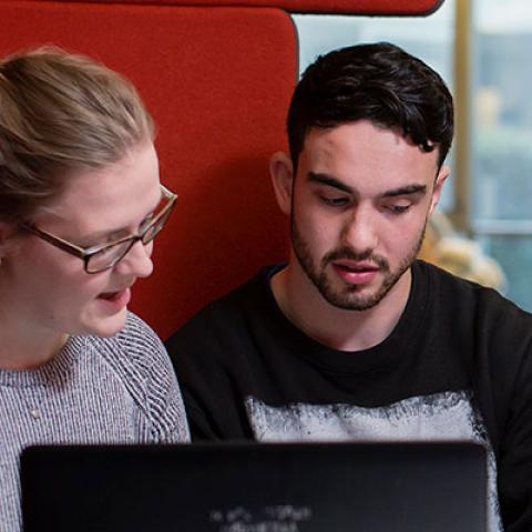 students in library working together