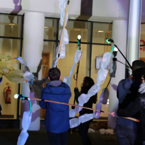 Scientists hold puppets made to communicate science