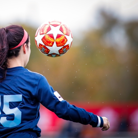 women playing football - Photo by Rhett Lewis on Unsplash