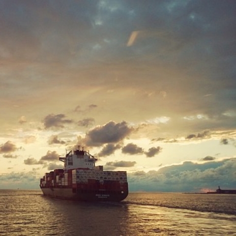 Image of a cargo ship at sunset