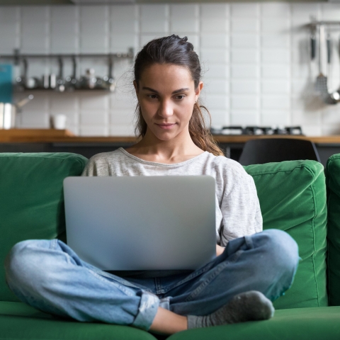 Female student relaxed at home with book