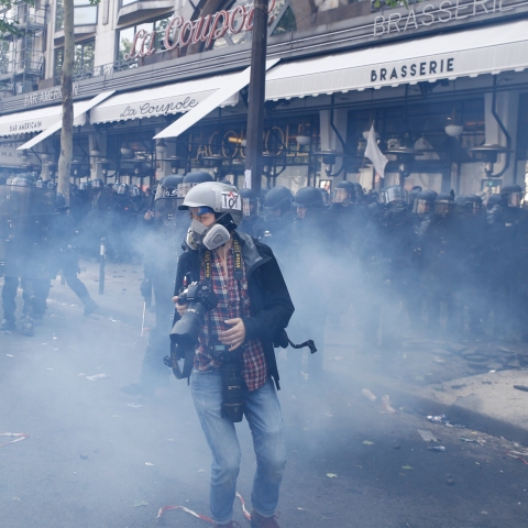 Photojournalist surrounded by riot police, Paris, France