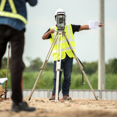 Civil engineers using surveying equipment