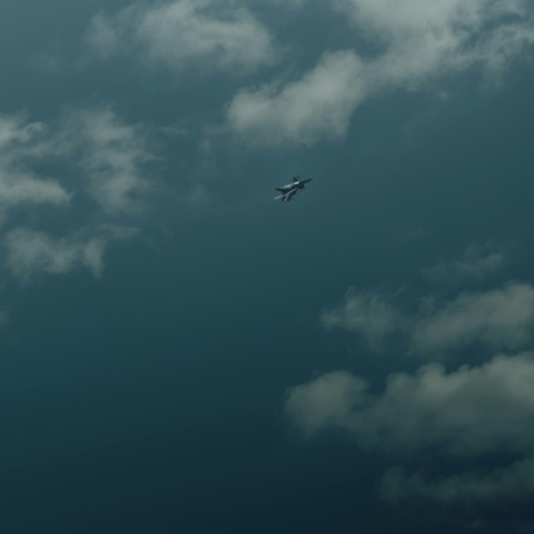 Military aircraft in cloudy sky