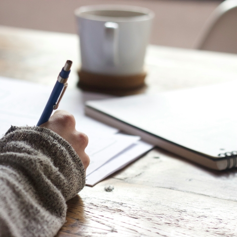 unsplash image of someone writing with a pen