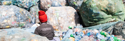 A person sorting plastic waste © James Wakibia