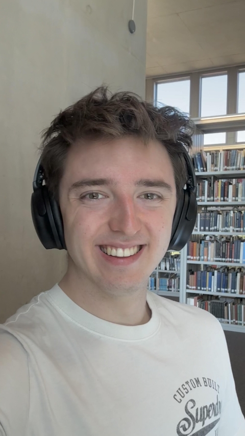 Student smiling and wearing headphones.