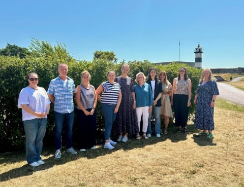 Group photo of PhD students stood by Southsea Castle