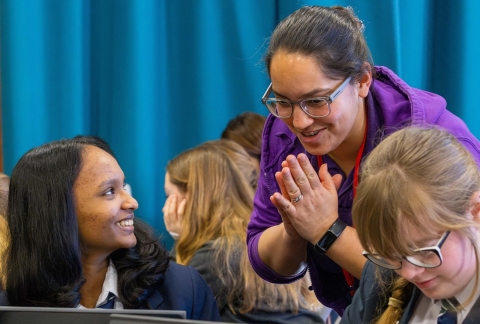 Image of University lecturer talking to pupils from Kings Academy Bay House at a digital skills workshop